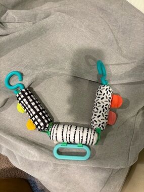 Black & White Patterned Infant Stroller Toy with Teal Clips